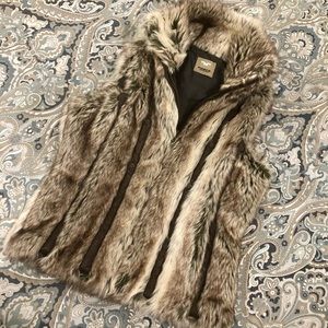 Beautiful, thick faux fur vest with suede trim and hardware detail.